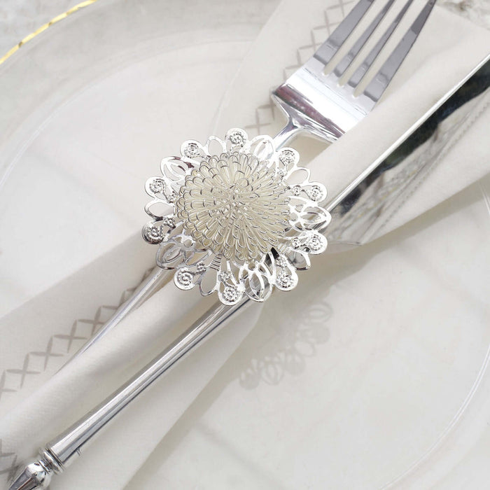 Silver floral napkin ring on cutlery with white napkin and plate