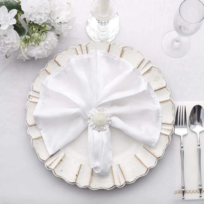 Elegant white napkin arranged beautifully on a decorative plate.