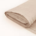 Folded beige fabric roll on a plain background.