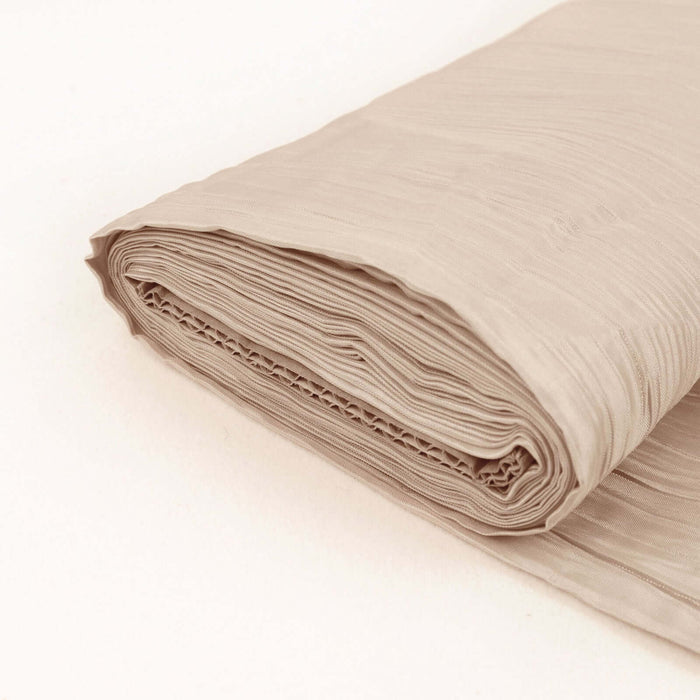 Folded beige fabric roll on a plain background.
