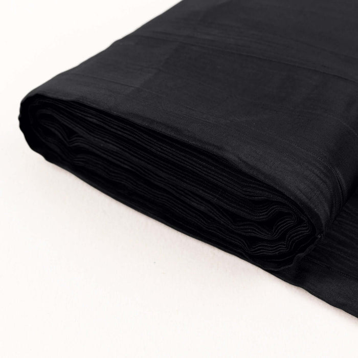 Black fabric roll, smooth texture, perfect for crafting and sewing projects.