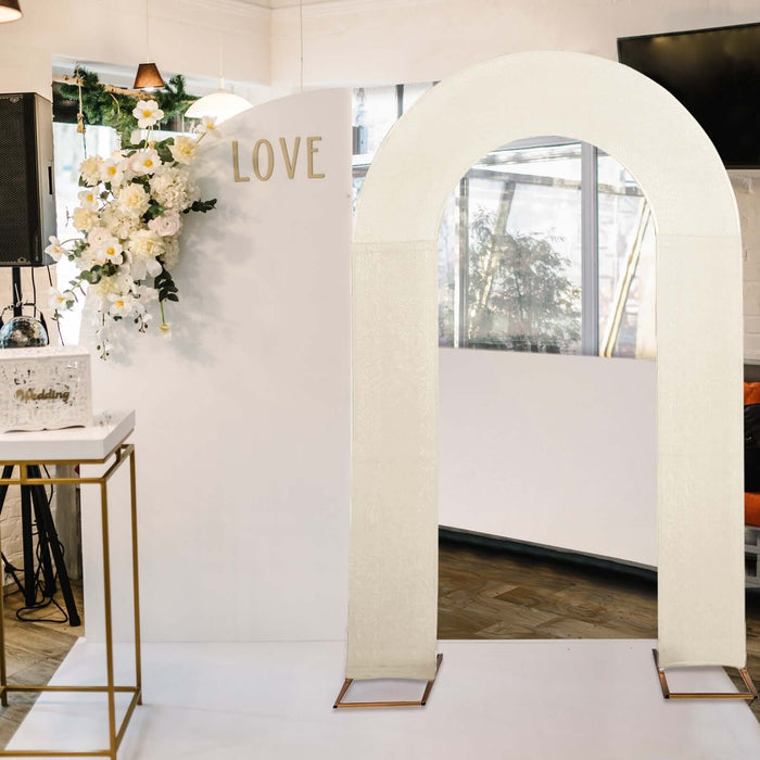 Wedding arch decoration with gold accents and floral backdrop.