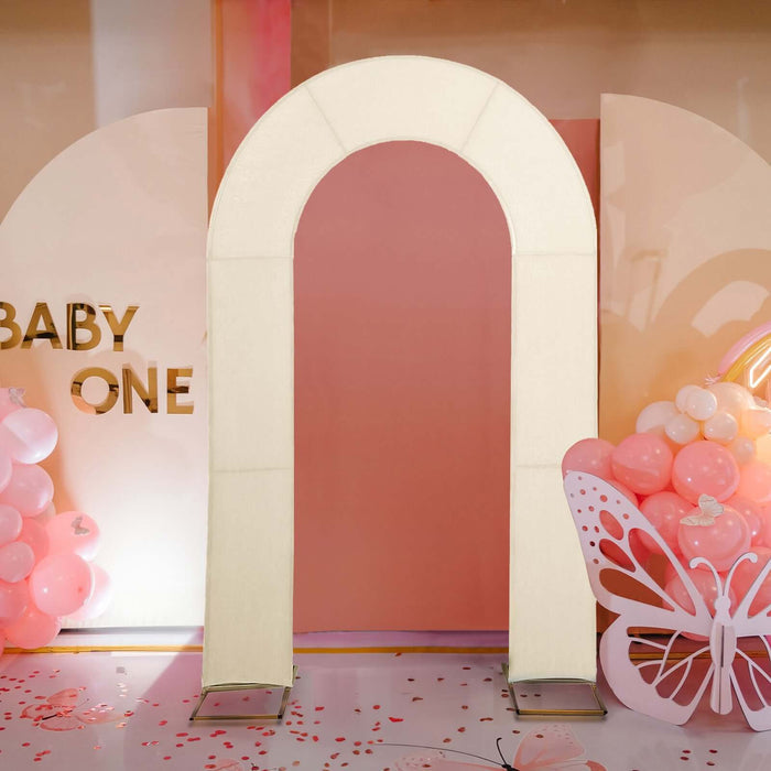 Decorative arch for baby-themed events against a pastel backdrop.