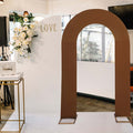 Brown wedding arch with "LOVE" sign in a stylish venue setting.