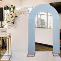 Blue wedding arch against a decorated backdrop with "LOVE" sign.