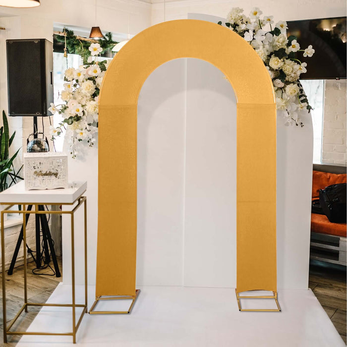 Gold wedding arch with floral arrangement, perfect for ceremonies and events.