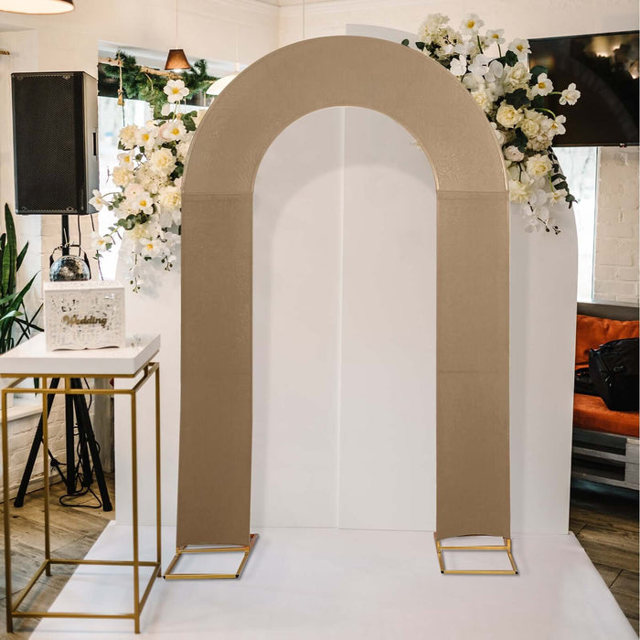 Beige arch decor with gold accents and floral arrangement in a venue setting.