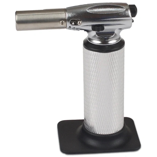 Butane torch with metallic nozzle and textured black base on a white background