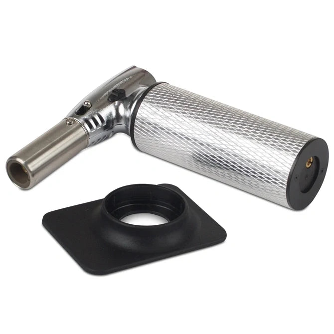 Butane torch with metallic nozzle and textured black base on a white background
