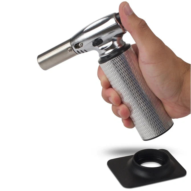 Butane torch with metallic nozzle and textured black base on a white background