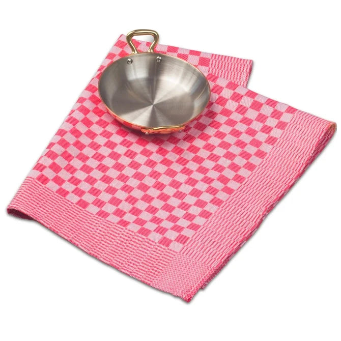 Red JB Prince kitchen towel with pan laying on top shot on white silo background.