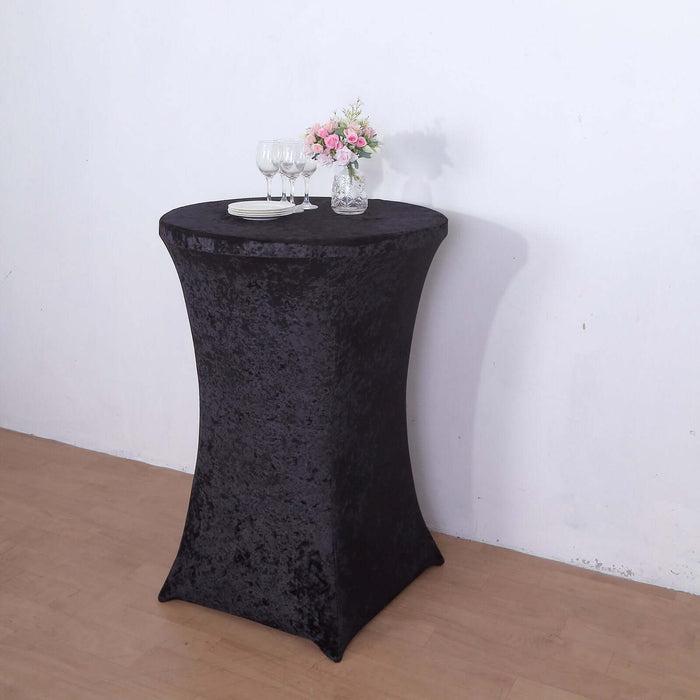 Black velvet table cover with floral centerpiece and glasses.