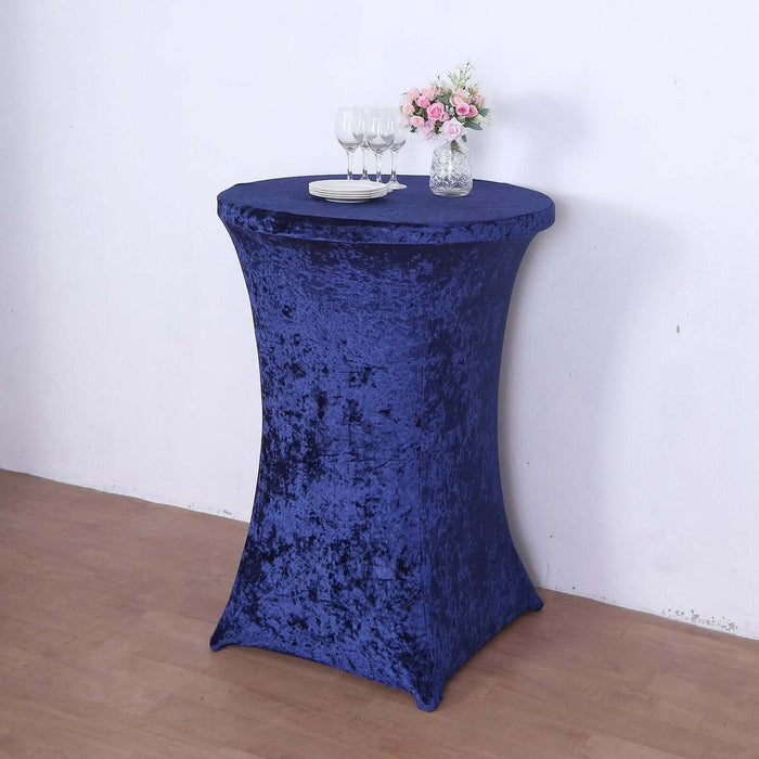 Navy blue stretch table cover on a high table with glasses and flowers