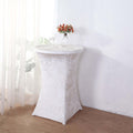White stretch table cover on a round table with a floral centerpiece.