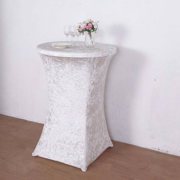 White stretch table cover on a round table with floral centerpiece
