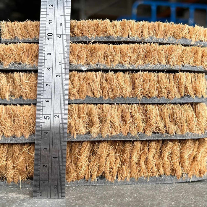 Coir matting with a ruler for scale on a concrete surface