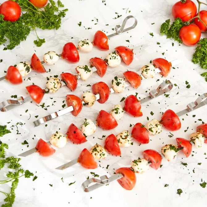 A set of six flat stainless steel skewers with looped ends, displayed against a white background.