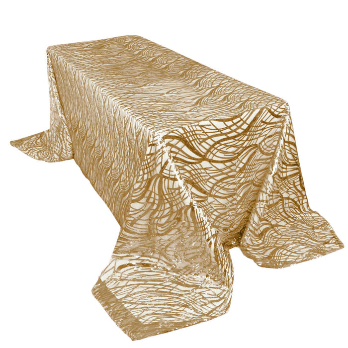 Gold patterned tablecloth on a rectangular table.