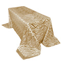 Gold patterned tablecloth on a rectangular table.
