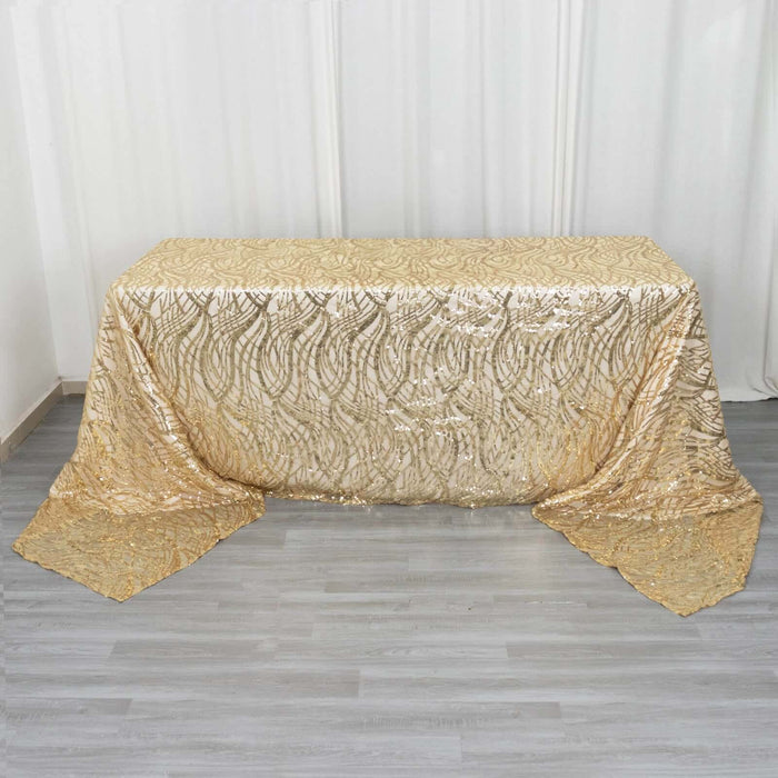 Gold sequin tablecloth with intricate design on a neutral backdrop.