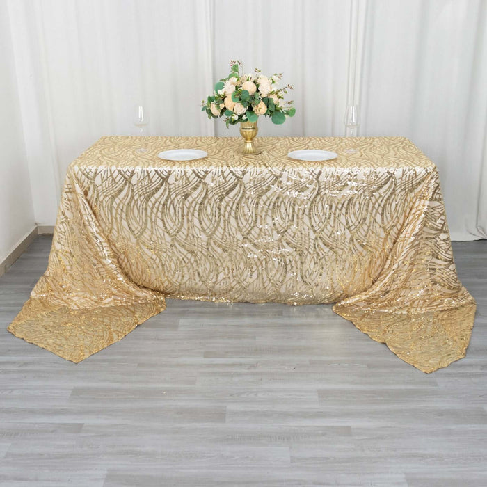 Gold sequin tablecloth with floral arrangement in a styled setting.