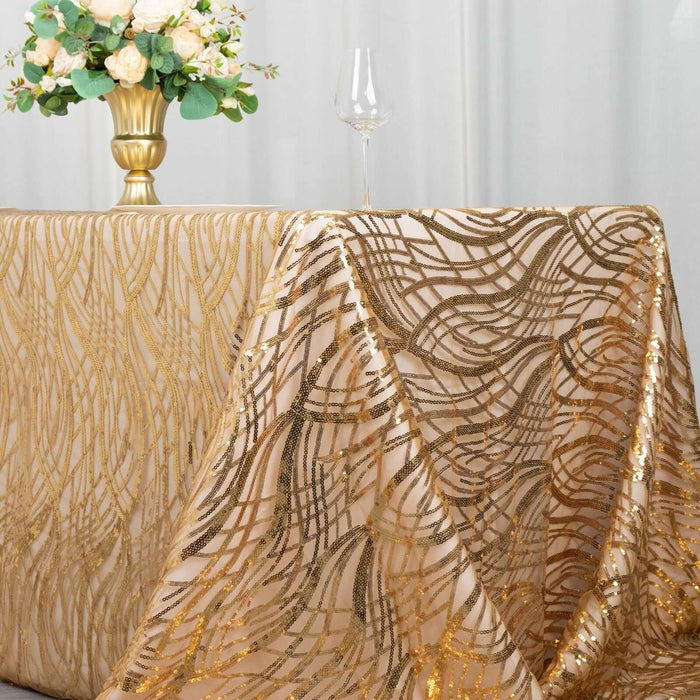Gold sequined tablecloth draped elegantly on a table with floral centerpiece.