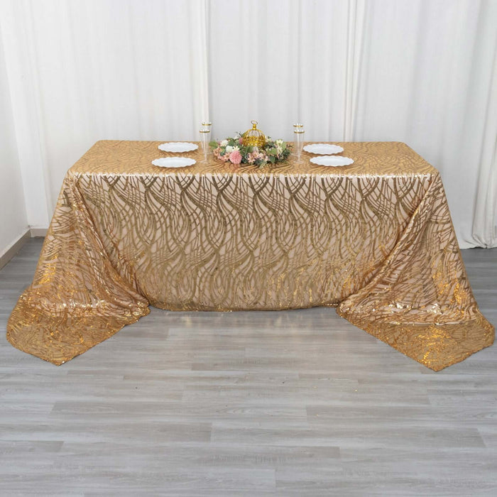 Gold patterned tablecloth draped over a table with decorative elements.