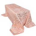 Rose gold patterned tablecloth on a white table.
