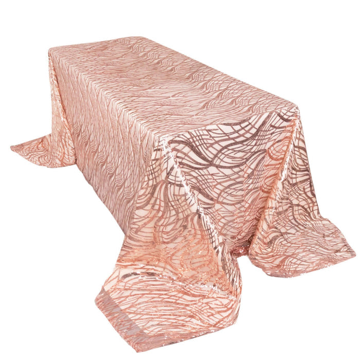 Rose gold patterned tablecloth on a white table.