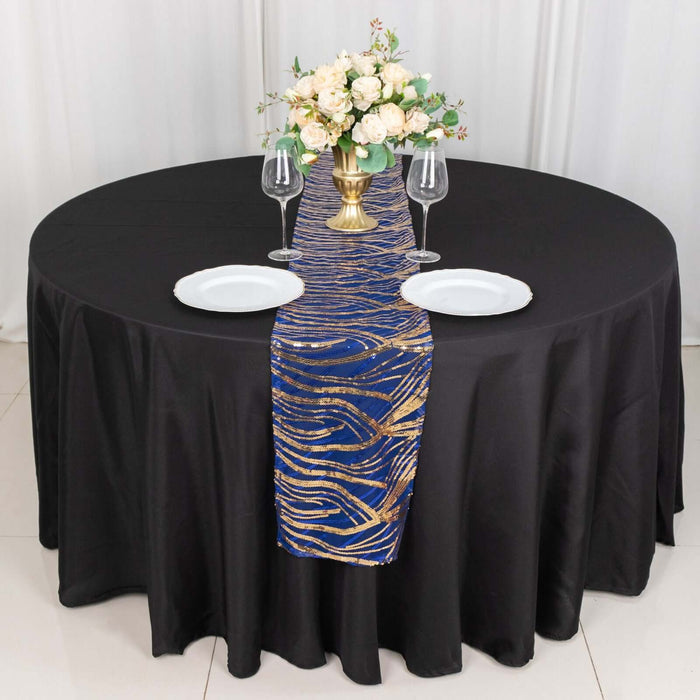 Elegant table setting with a blue and gold runner, plates, and floral centerpiece.