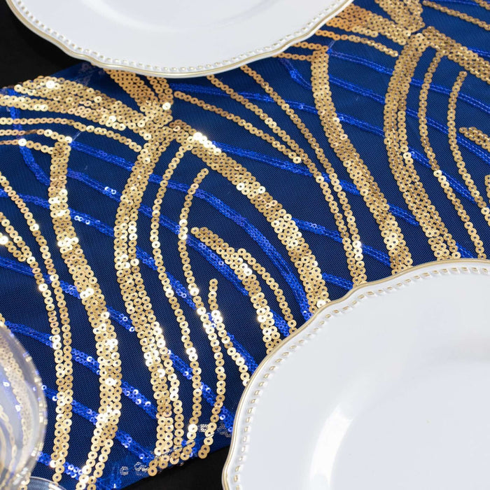 Blue and gold sequin table runner with decorative plates on a black surface.