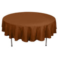 Brown round tablecloth on a plain backdrop