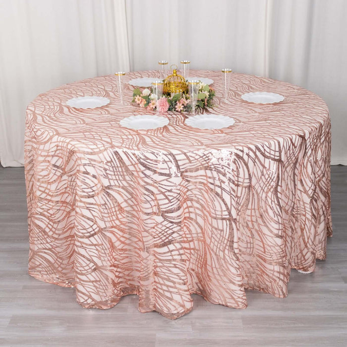 Rose gold tablecloth with elegant wave pattern on round table.