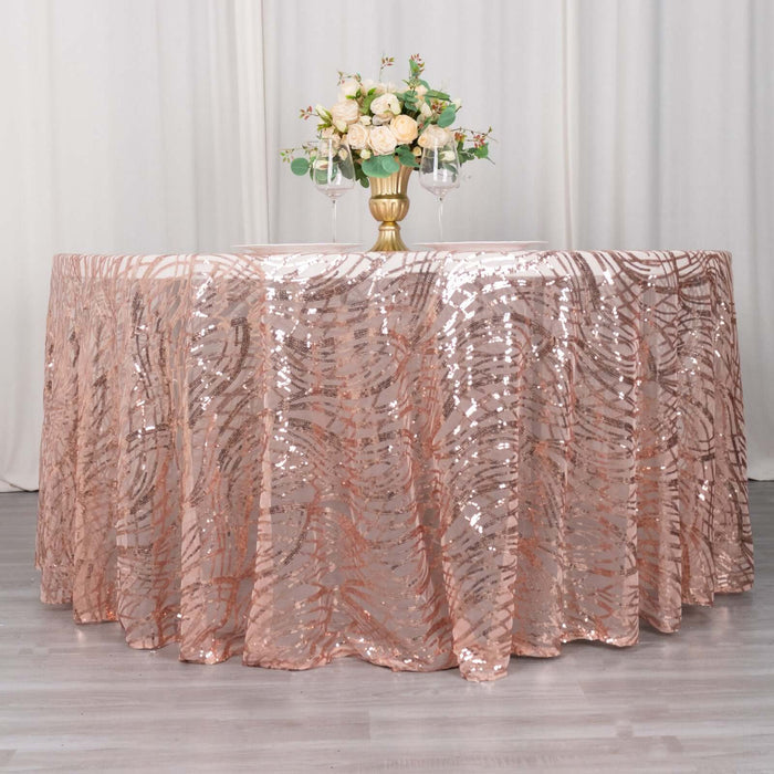 Rose gold sequin tablecloth draped over a round table with floral centerpiece.