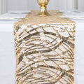 Gold sequined table runner on a white table with elegant decor.