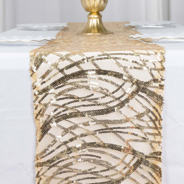 Gold sequined table runner on a white table with elegant decor.