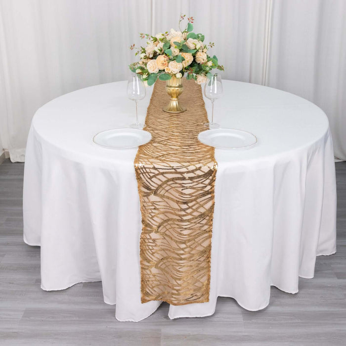 Elegant round table set with a gold runner and floral centerpiece.