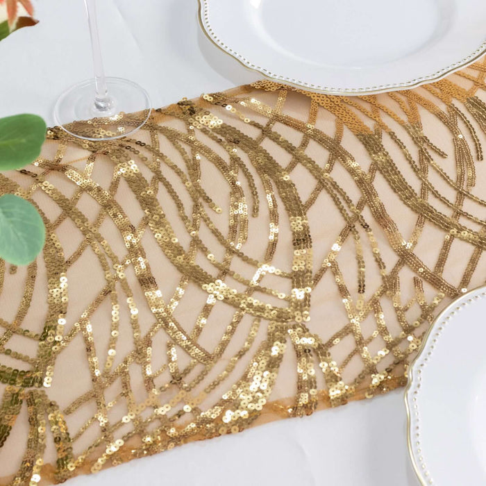 Gold sequin table runner with intricate design on a white table setting.