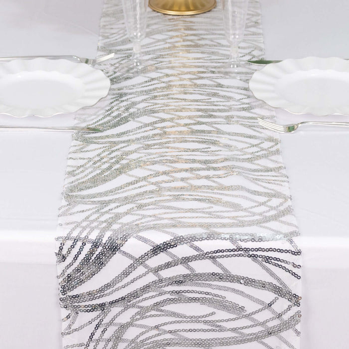 Elegant silver and white table runner with wavy patterns.
