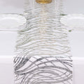 Elegant silver and white table runner with wavy patterns.