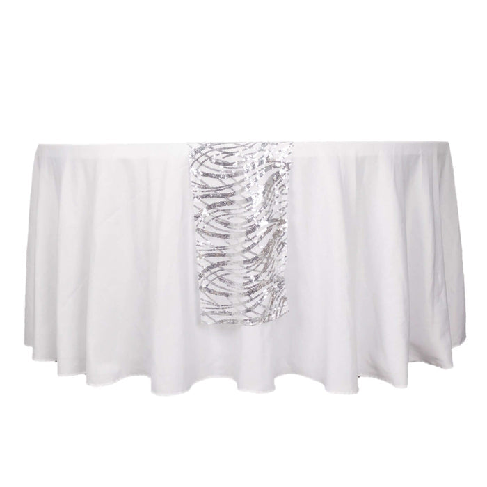 White tablecloth with a silver patterned runner.