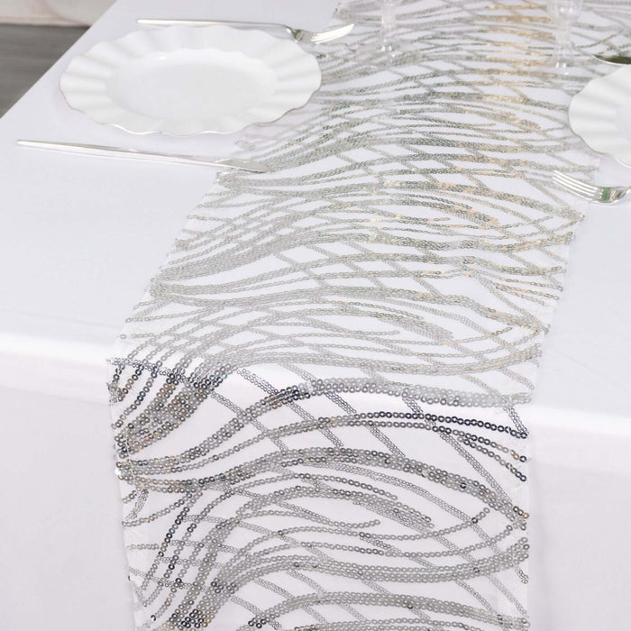 Silver wave-patterned table runner on a white table.