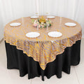 Elegant round table setting with decorative lace tablecloth and white plates.