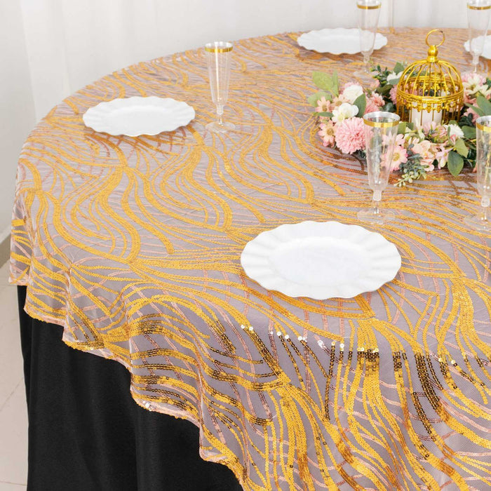 Elegant gold and silver tablecloth draped over a round table with decorative plates.
