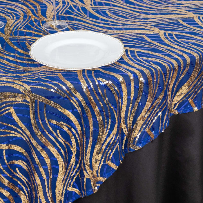 Navy blue and gold sequin tablecloth with wavy pattern on a black table.