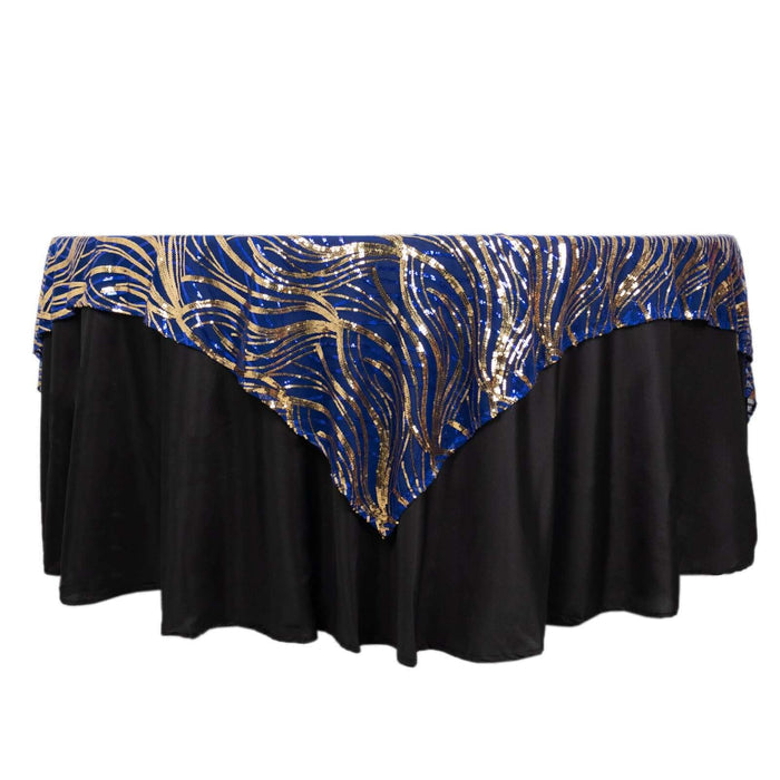 Blue and gold sequined tablecloth draped over a black table.