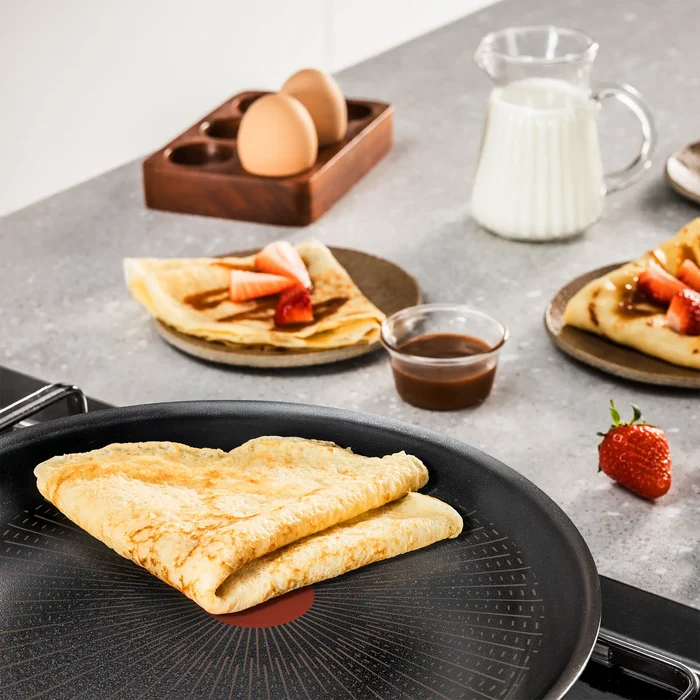 Tefal Excellence+ Induction FusionCore Non-Stick Pancake Pan 25cm on kitchen bench with cooked crepe