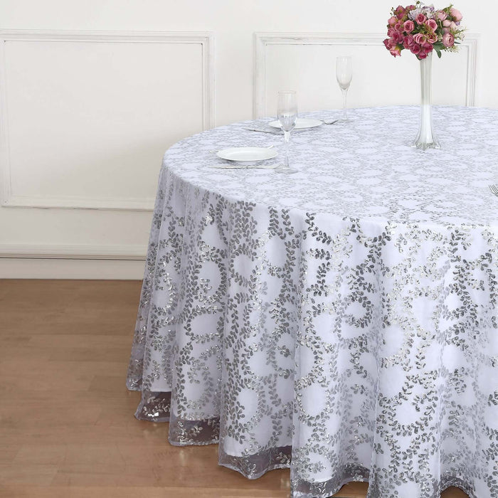 White lace tablecloth draped over a round table with floral centerpiece.