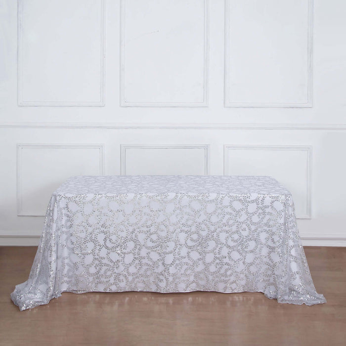 White lace tablecloth draped over a table in a minimalist setting.