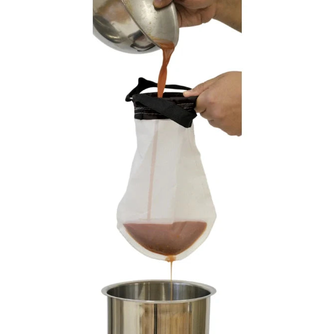 Ultra Bag Flexible Sieve straining into a bain marie on white background.